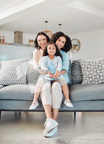 Image of Grandmother, mother and girl on sofa for portrait in living room, home or happy together for a hug or quality time in house. Smile, face of mom and elderly person relax with young child in embrace