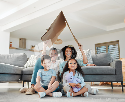 Image of Cardboard roof, portrait and a family in a lounge for security, safety and shelter as a family. Happy, house and a mother, father and children with refuge in a living room for insurance together