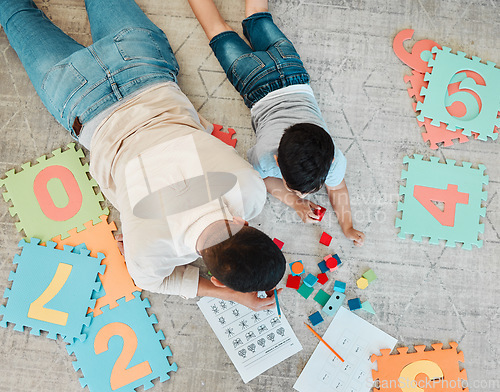 Image of Building blocks, top or father with kid on the floor for learning, education or child development at home. Family, play or dad enjoying bonding time in living room with boy or toys doing homework