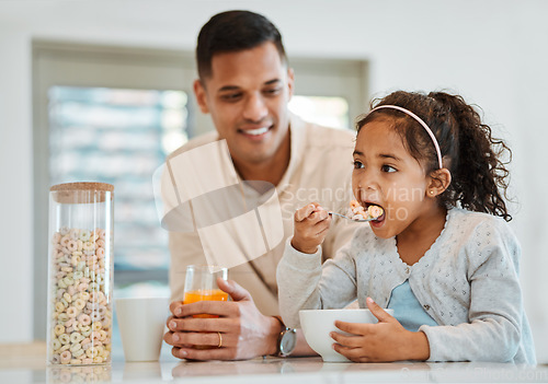 Image of Eating, morning and a child with father for breakfast, food in the kitchen and care for nutrition. Smile, together and a young dad with a girl kid with cereal in a house for health and hungry