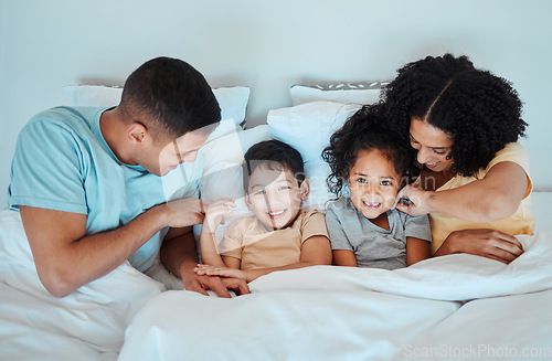 Image of Top view, family and parents with children in bed for bonding, quality time and affection in morning. Happy, love and portrait of mother, father and kids in bedroom for fun, sleeping and relaxing