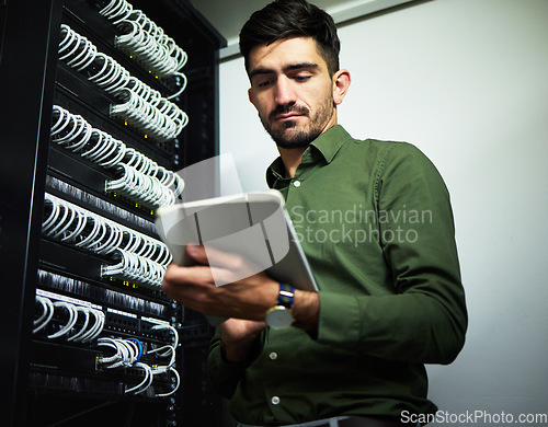 Image of Engineer man, cable and server room with a tablet for programming, maintenance and software upgrade. Young male technician person with technology in data center for wire, hardware and internet