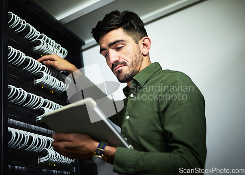 Image of Server room, cable and engineer man with a tablet for programming, maintenance and software upgrade. Young technician person with technology in data center for problem solving and internet connection