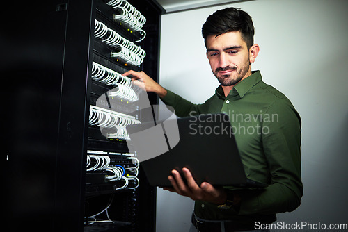 Image of Laptop, engineering and man technician in a server room for technical repairs by a control box. Technology, maintenance and professional male electrician working on computer for cybersecurity system.