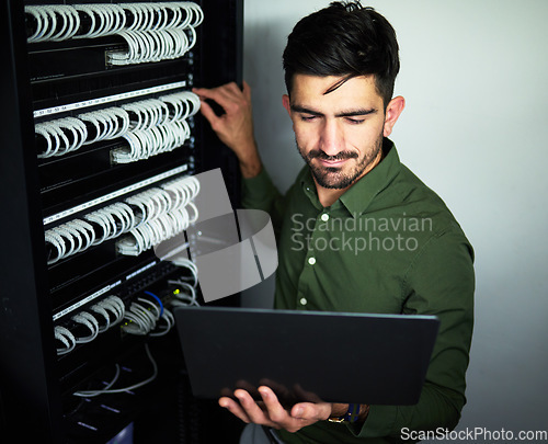 Image of Laptop, data center and male technician in a server room for technical repairs by a control box. Technology, engineering and professional man electrician working on computer for cybersecurity system.