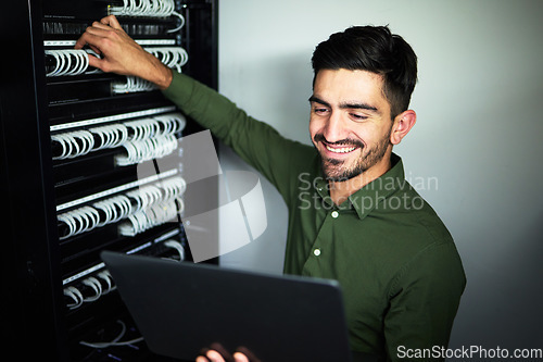 Image of Laptop, maintenance and male technician in a server room for technical repairs by a control box. Technology, engineering and professional man electrician working on computer for cybersecurity system.