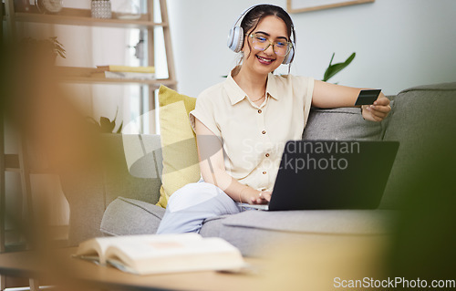 Image of Happy woman, credit card and laptop with headphones in home for ecommerce sales, fintech password and online shopping. Female customer, computer banking and code to upgrade music subscription account