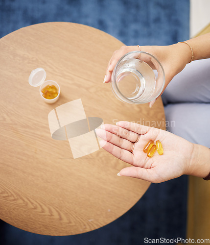 Image of Top view of hands, pills and water in glass for sick woman, iron supplements and cure at home. Capsule tablets, prescription drugs and vitamins in palm for wellness product, medicine and healthcare