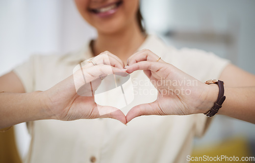Image of Closeup, heart and hands of woman for care, charity and kindness of donation at home. Female person with finger shape for love icon, thank you and emoji reaction in support of freedom, review or hope
