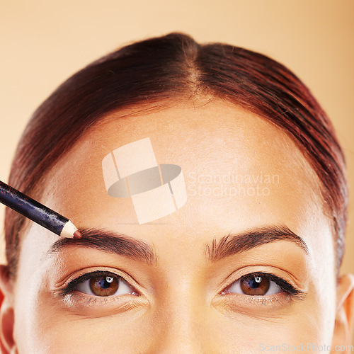 Image of Makeup, eyebrow pencil and woman with cosmetic beauty application in portrait isolated in studio background. Closeup, facial or person with face for microblading aesthetic, glow or glamour product