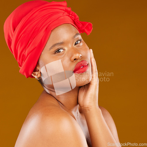 Image of Beauty, woman and trendy wrap with face and red lips portrait and scarf for care and wellness in studio. Brown background, female person and cosmetics with African model and makeup for facial glow