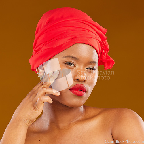 Image of Beauty, woman and wrap with healthy face and red lips portrait and scarf for care and wellness in studio. Brown background, female person and cosmetics with African model and makeup for facial glow