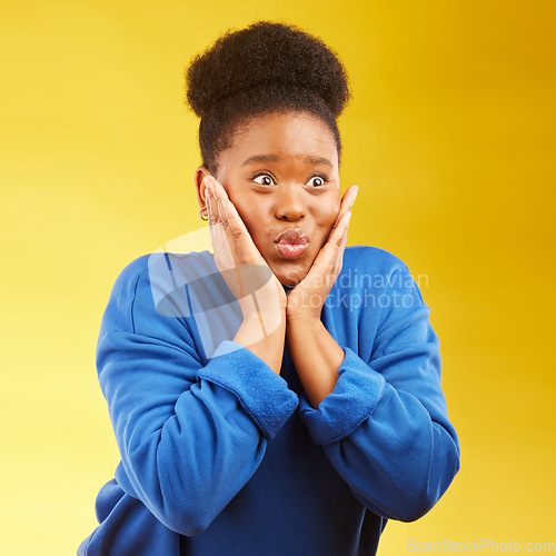 Image of Wow, excited and hands on face of black woman in studio with news, deal or giveaway promo on yellow background. Omg, surprise and shocked African female with announcement, gossip or sign up prize