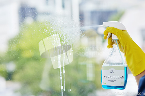 Image of Hands, cleaning spray and bottle at windows for hygiene of bacteria, dust and germs. Closeup, housekeeping and cleaner with chemical liquid product for dirt, glass surface and hospitality services