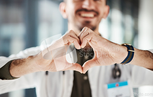 Image of Hospital doctor, happy man and closeup heart hands for surgeon healthcare, medical services and cardiology health. Medicine satisfaction, emoji love icon and clinic person with nursing wellness care