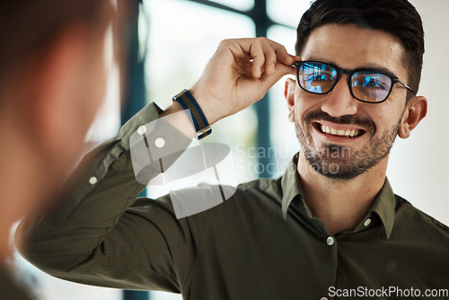 Image of Face, man and smile with glasses in mirror for vision, eyesight and prescription lens. Happy male customer with choice of frame for designer eyewear, optical fashion and assessment in eye care clinic