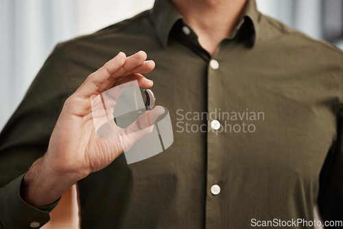 Image of Hearing aid, business man with disability and hands show communication implant for support, listening and medical innovation. Closeup of deaf person with audiology tech to help volume of sound waves