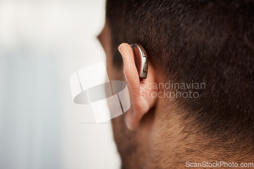 Image of Closeup of hearing aid, ear and man with disability from the back for medical support, listening or healthcare at mockup space. Deaf patient, face and audiology implant to help volume of sound waves