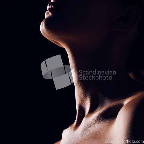 Image of Skincare, neck and person on black background for creative lighting, shadow and silhouette. Aesthetic, beauty and closeup of body in dark studio with macro of skin for art deco, wellness and glow