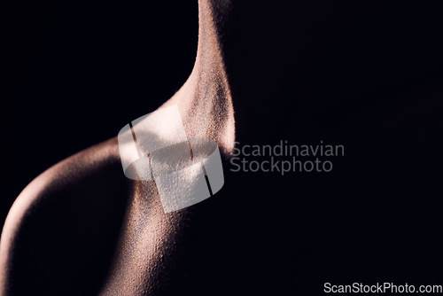 Image of Beauty, neck and person on black background for creative lighting, shadow and silhouette. Aesthetic, fantasy and closeup of body in dark studio with macro of skin for art deco, wellness and glow