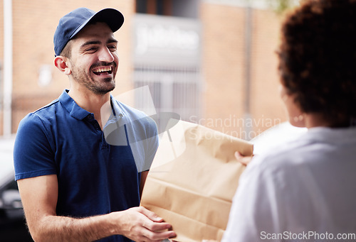 Image of Happy delivery man, package and a customer at door with a paper bag for e commerce and shipping. Logistics, online shopping and freight or courier worker laughing and giving a woman a fast food order