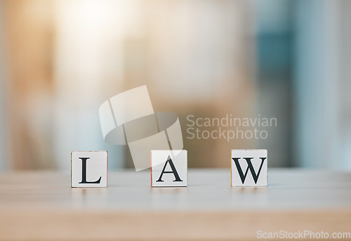 Image of Table, office and block cubes with law letter in office with blur background for customer or business. Support, service and frequently asked questions for regulation with company in mock up space.