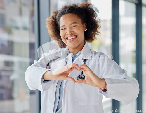 Image of Black woman, heart and hands of doctor in portrait for healthcare, wellness and kindness. Happy female cardiology worker, finger shape and trust for love emoji, icon and thank you in medical hospital