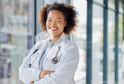 Image of Happy black woman, portrait and doctor with arms crossed in clinic for wellness services, help or medical consulting. Medicine, healthcare and young female professional working with trust in hospital