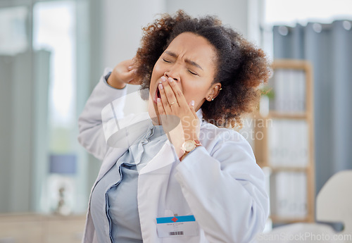 Image of Tired doctor, woman and yawn in hospital with burnout, medical stress and working with low energy in clinic. Fatigue of black female healthcare worker yawning while feeling overworked, sleepy or lazy