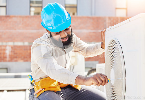 Image of Man, technician or repair for air conditioner on rooftop in city for box or industrial labor outdoors. Maintenance, engineer or contractor fixing hcav on roof for installation or machine inspection