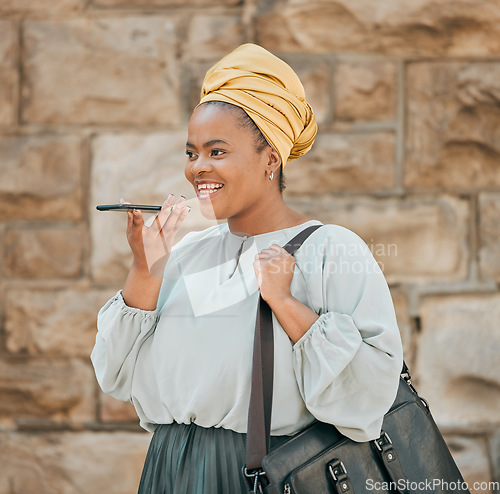 Image of Young woman on loudspeaker phone call in the city walking in urban street with a briefcase. Voice note, technology and African female designer recording audio memo or message on a cellphone in town.