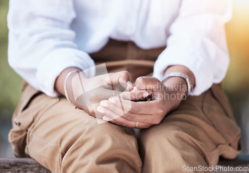 Image of Hands anxiety, sitting and a person in nature on a bench to relax in summer for a vacation or break. Nervous, flare and a woman or girl in a park for rest, closeup or waiting in a natural environment