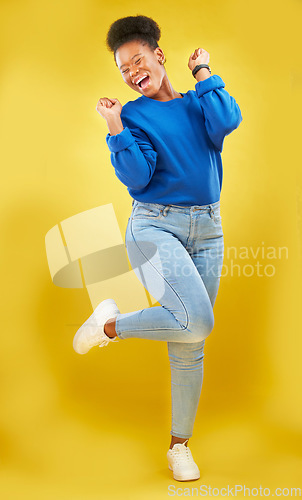 Image of Happy, dance or black woman in studio for celebration, achievement or goal with confidence. Moving, smile or African female model with pride, success or joy for target isolated by yellow background
