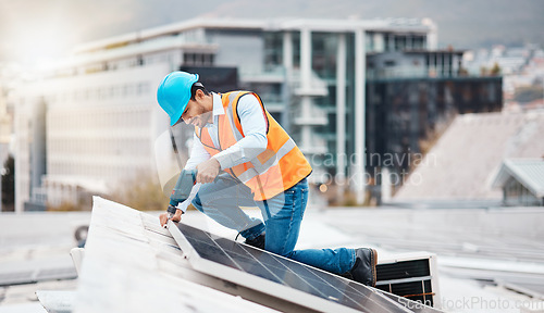 Image of Solar panel, drill and engineering with man on roof top for renewable energy, project and power. Construction, electricity and sustainability with contractor in city for tools, photovoltaic and grid