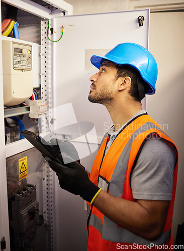 Image of Tablet, electricity and man with control box for repair, maintenance and inspection for power. Engineering, electrician and male worker on digital tech online for service, construction and labor