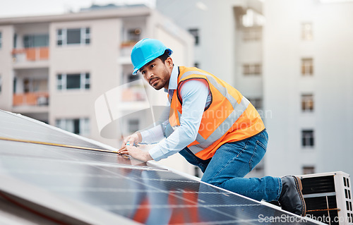Image of Technician man, tape and solar panel on roof with thinking, sustainable vision and construction in city. Engineer, tools and photovoltaic system with building, measuring and renewable energy in cbd