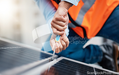 Image of Solar panels, tool and closeup of male engineer doing maintenance or repairs with screwdriver. Renovation, handyman and zoom of an industrial worker working on eco friendly construction on rooftop.