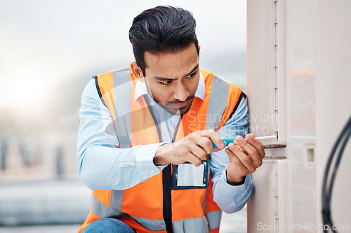 Image of Tools, engineering and man with air conditioner for maintenance, repair and inspection on roof. Solar power, construction and male worker with equipment for service, installation or electricity check