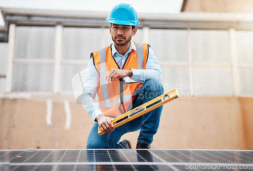 Image of Solar panel, grid and engineering with man on roof top for renewable energy, project and power. Construction, electricity and sustainability with contractor in city for tools, photovoltaic and safety