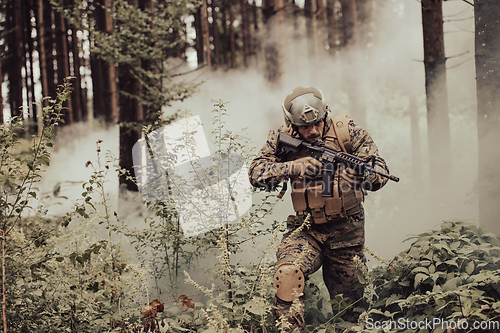 Image of A modern warfare soldier on war duty in dense and dangerous forest areas. Dangerous military rescue operations