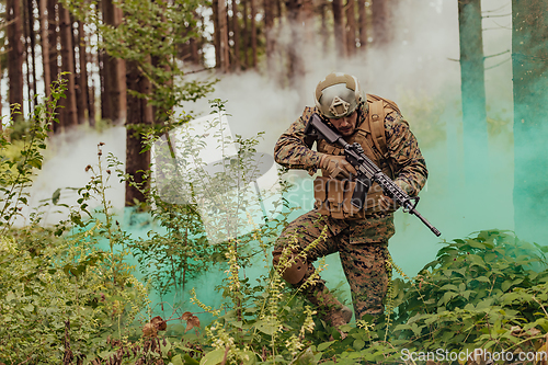 Image of A modern warfare soldier on war duty in dense and dangerous forest areas. Dangerous military rescue operations