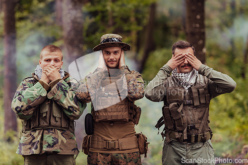 Image of Group of soldiers in oposit sides celebrating peace after battle by showing blind mute and deaf symbols