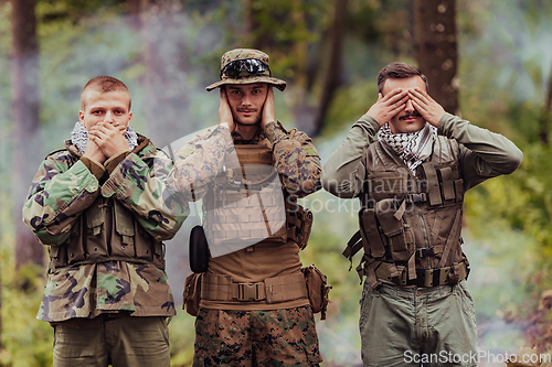 Image of Group of soldiers in oposit sides celebrating peace after battle by showing blind mute and deaf symbols