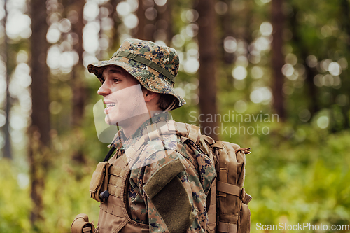 Image of A modern warfare soldier on war duty in dense and dangerous forest areas. Dangerous military rescue operations