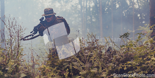 Image of A modern warfare soldier on war duty in dense and dangerous forest areas. Dangerous military rescue operations