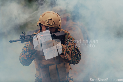 Image of A soldier fights in a warforest area surrounded by fire