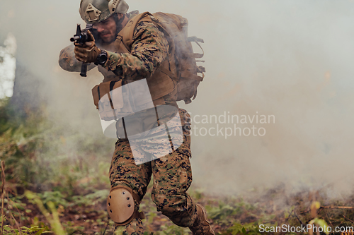 Image of A soldier fights in a warforest area surrounded by fire