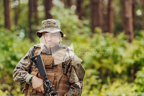 Image of A modern warfare soldier on war duty in dense and dangerous forest areas. Dangerous military rescue operations