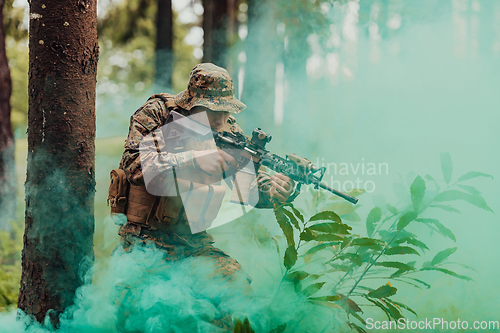 Image of A modern warfare soldier on war duty in dense and dangerous forest areas. Dangerous military rescue operations