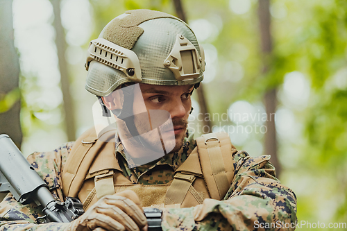 Image of American marine corps special operations soldier preparing tactical and commpunication gear for action battle closeup